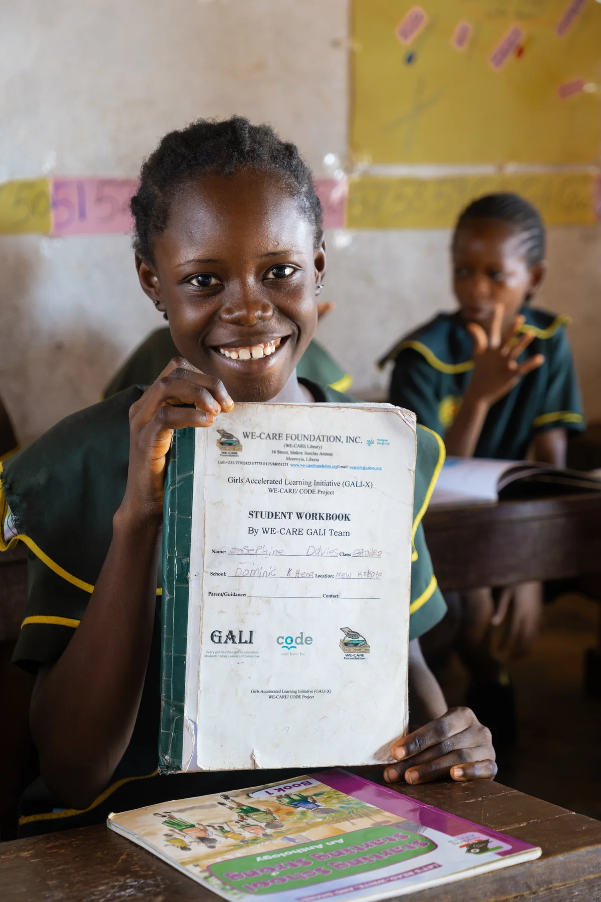 Girl holding her GALI-X workbook