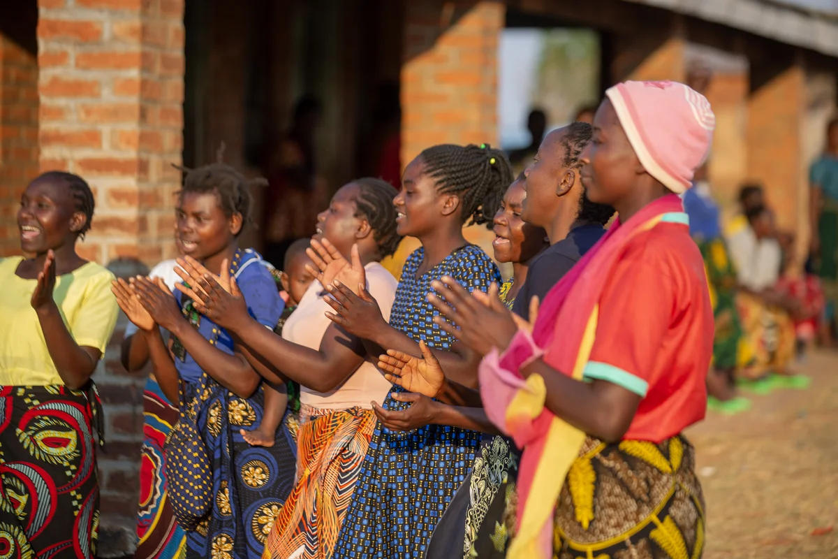 Community members clapping together at an iHEARD gathering