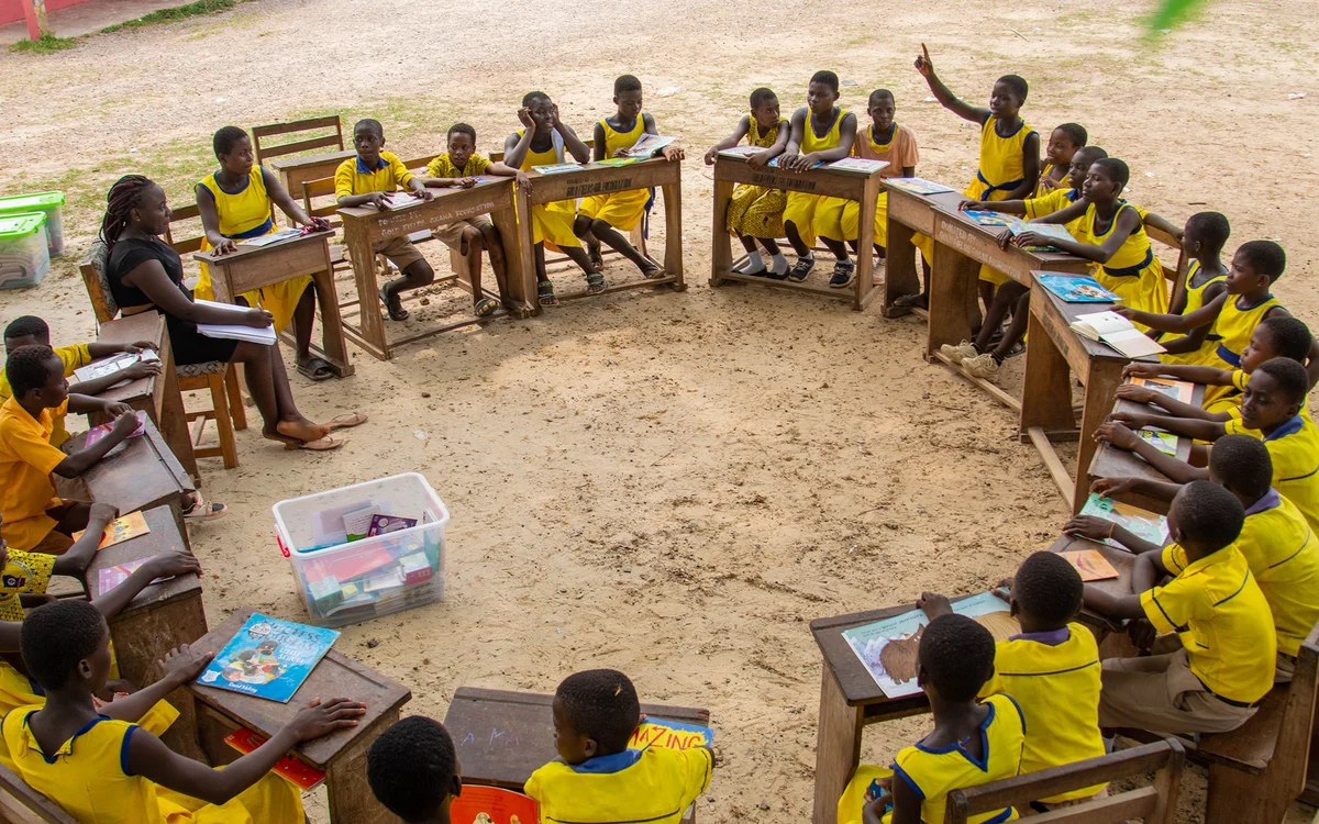 Aerial view of students seated in a circle at a Reading Ghana reading club