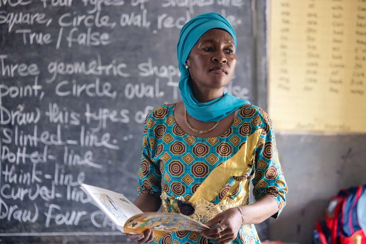 Student teacher leading a lesson at the chalkboard in Sierra Leone