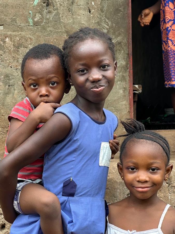 Sallay’s smile stood out to us as we approached a group of children in Allen Town, Sierra Leone. Her energy shone through the curious faces that had gathered to greet us.