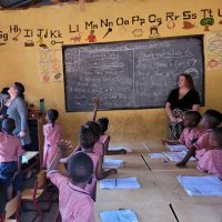 CODE CEO Janice Ciavaglia (left), CFO Carly Virtue (centre), and I (right), engaging with curious learners during our visit to Sierra Leone.