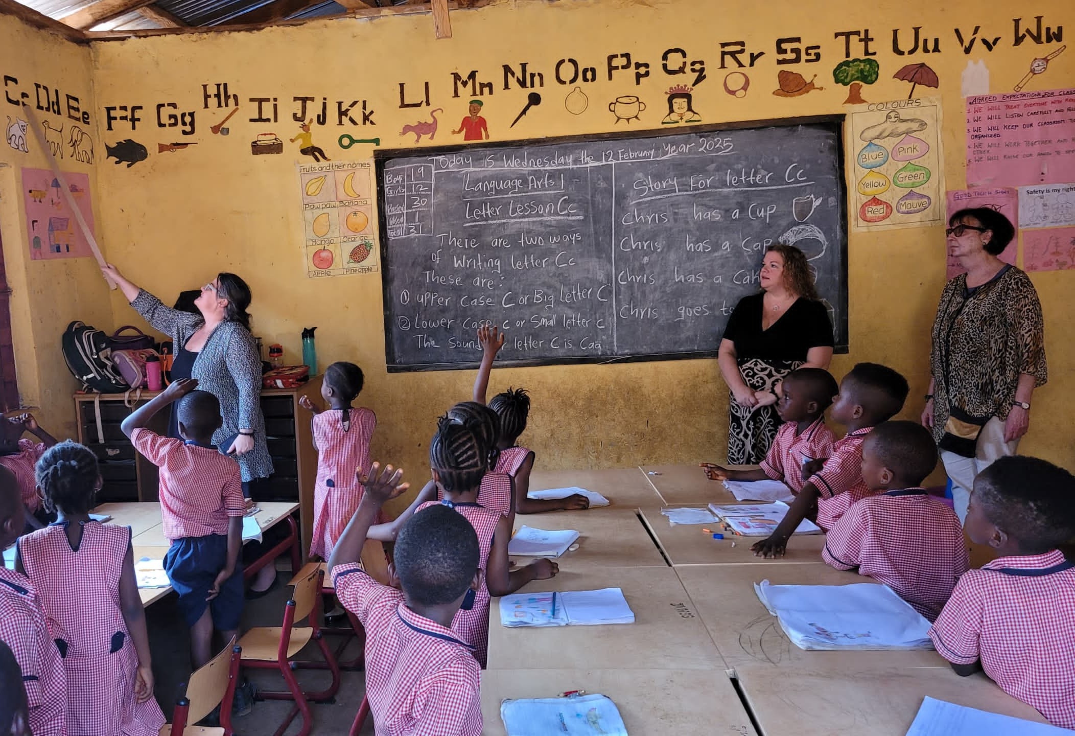 CODE CEO Janice Ciavaglia (left), CFO Carly Virtue (centre), and I (right), engaging with curious learners during our visit to Sierra Leone.
